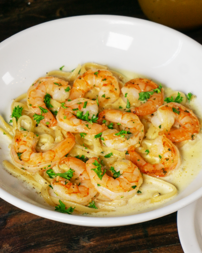 Fetuccini Alfredo con camarones y pan de ajo
